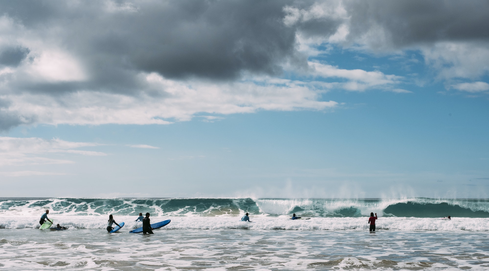 Young men surfing in sea